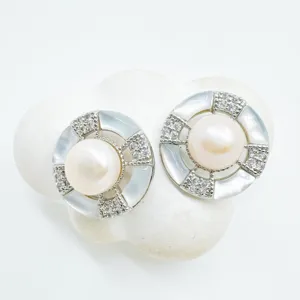 Elegant geometric pearl stud earrings detailed with shimmering mother of pearl and pavé crystals.