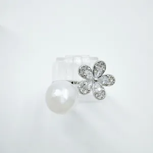 Detailed shot of elegant pearl and crystal flower ring sparkling cubic zirconia design piece.