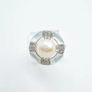 Close-up of the geometric pearl ring featuring mother-of-pearl and dazzling cubic zirconia.