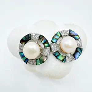 Exquisite geometric pearl earrings detail featuring mother-of-pearl and pavé zircons.