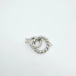 Détail de fermoir de bijoux torsadé argenté, idéal pour colliers DIY, connecteur sécurisé.