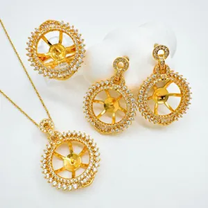 Detailed view of DIY jewelry blank mounts set including pendant ring and earrings in gold.