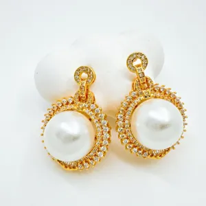 Exquisite gold-plated pearl drop earrings featuring sparkling cubic zirconia pave details.