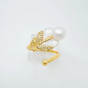 Detail shot of gold-plated feather pearl open ring, featuring mother-of-pearl and sparkling zircon.