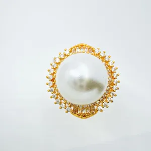 Detail view of gold rhinestone pearl jewelry blank setting for DIY ring pendant accessory.