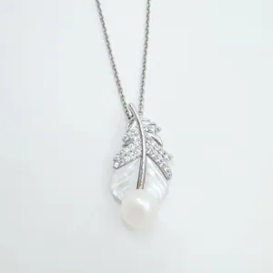 Detailed view of silver feather necklace with mother of pearl and a dangling white pearl.