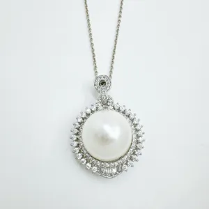 Elegant sterling silver pearl pendant necklace with sparkling cubic zirconia halo details.