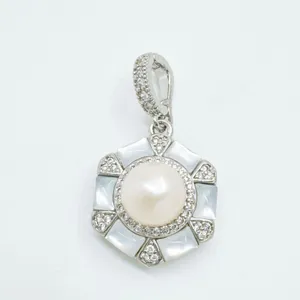Close-up detail of hexagonal mother-of-pearl pendant with central pearl and crystal pave.