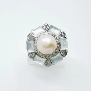 Close-up of elegant hexagonal pearl ring setting with mother of pearl and pave cubic zirconia.