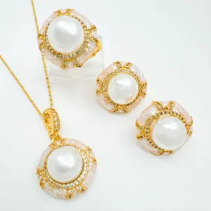 Detailed view of luxury pearl jewelry set featuring necklace pendant, ring, and earrings.