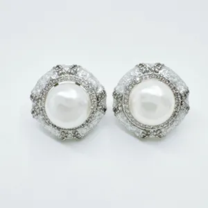 Vintage style pearl earrings featuring sparkling crystal rhinestones and elegant design.