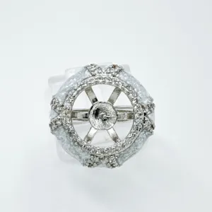 Detailed close-up of DIY jewelry blank ring setting featuring geometric wheel design with crystals.