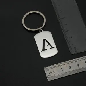 Stainless steel letter A keychain detail view, silver dog tag pendant hardware closeup.