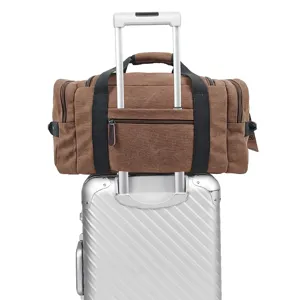 Vintage canvas travel duffel bag with trolley sleeve and durable handles for luggage.