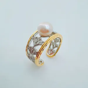 Close-up detail view of the elegant open pearl ring featuring dual-tone metal and cubic zirconia.