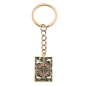 Porte-clés en métal avec pendentif étoile boussole détaillé, accessoire doré chic.