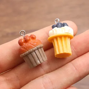 Gros plan de charmants pendentifs gâteau en résine miniature pour la fabrication de bijoux.