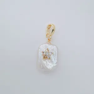 Baroque freshwater pearl pendant with gold plated clasp and sparkling zircon star charm detail.