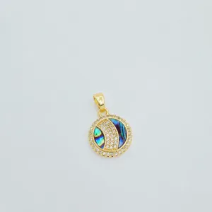 Close-up of the round gold plated pendant with abalone shell and sparkling zirconia stones.