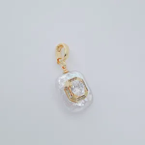 Closeup view of the baroque freshwater pearl pendant with gold plated clasp and crystal detail.