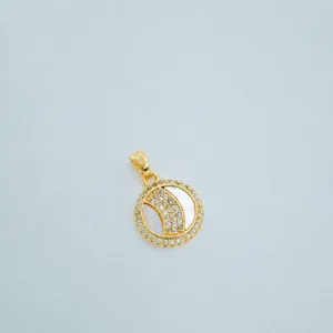Gold plated tennis ball pendant with white mother of pearl and sparkling cubic zirconia details.