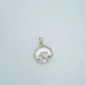 Detailed view of copper lotus pendant featuring mother of pearl and cubic zirconia.