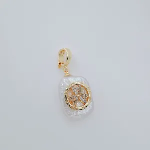 Close-up detail of luxury baroque pearl pendant featuring rhinestone clover motif with roman numerals.