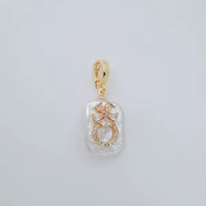 Gold plated pearl pendant detail, baroque freshwater pearl with sparkling cubic zirconia flower.