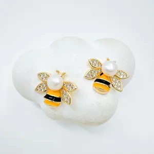 Elegant pearl bee stud earrings with rhinestone wings and gold plated fashion jewelry.