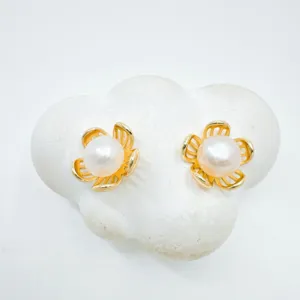 Exquisite gold-plated pearl flower stud earrings, elegant detail display showing glossy texture.