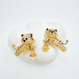 Gold-plated rhinestone tiger stud earrings, exquisite animal jewelry detail close-up.