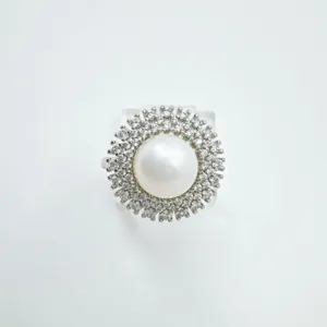 Exquisite pearl ring detail showcasing double halo zirconia setting and elegant polished metal.