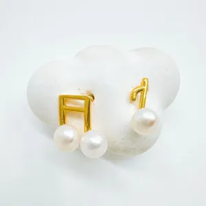 Elegant pearl music note earrings, gold-plated copper dainty jewelry accessory for women details.