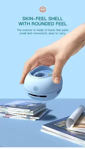Handheld mini desktop vacuum cleaner detail showing portable spherical design and smooth shell.