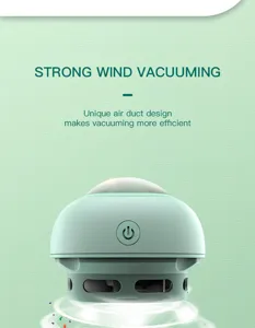Detailed view of the mini desktop vacuum cleaner showing power button and efficient air vent design.