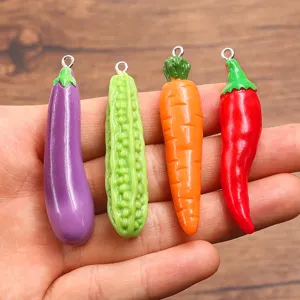 Resin vegetable charms detail view featuring miniature eggplant carrot chili bitter gourd pendants