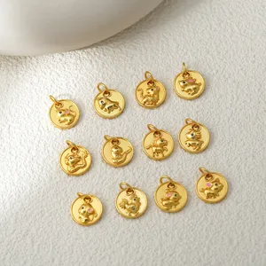 Close-up detail of small round gold-colored zodiac charms, showing exquisite animal textures.