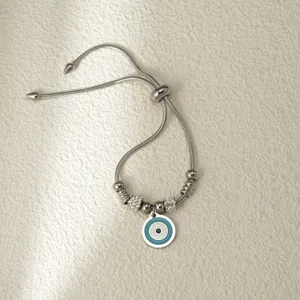 Pulsera ajustable de acero inoxidable con colgante de mal de ojo y detalles de estrás