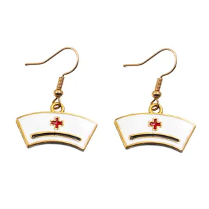 Detailed close-up of nurse hat enamel drop earrings featuring a red cross and gold hook.