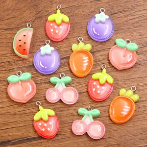 Detailed shot of assorted DIY resin fruit and vegetable charms with metal loops for crafts.