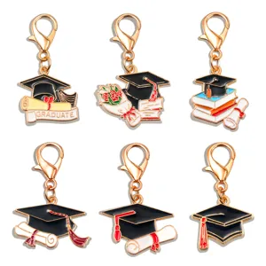 Graduation metal alloy charms detailed view showing mortarboard and diploma designs