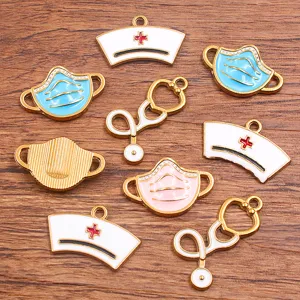 Detailed view of gold plated medical theme enamel charms including nurse caps and stethoscopes.
