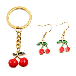 Detailed shot of enamel cherry keychain and matching earrings, KC gold alloy jewelry making accessories