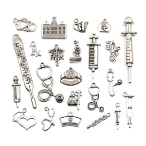Detailed view of 23 vintage medical theme metal alloy charms, perfect for DIY jewelry making.