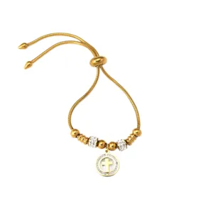 Pulsera ajustable de acero inoxidable dorada con colgante de cruz y cuentas de cristal.
