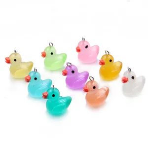 Nahaufnahme von bunten Harz-Enten-Anhängern, süße Mini-Anhänger mit Metallösen für DIY-Basteln.