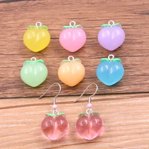 Colorful resin peach charm pendants and earrings set for DIY jewelry making and accessories.