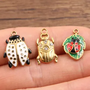 Close-up detail view of gold-plated enamel insect charms, featuring cute beetle and ladybug designs.