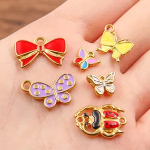 Colgantes mariposa lazo esmalte oro de acero inoxidable para accesorios joyas DIY.