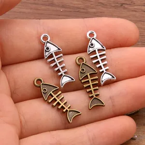 Close-up view of fishbone pendants in silver and bronze colors, showing diy jewelry details.